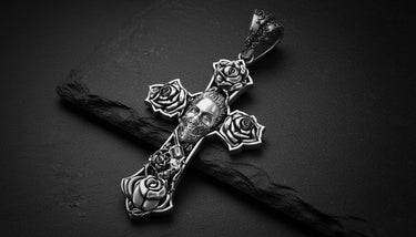 925 sterling silver Chicano cross pendant with skull and rose details displayed on dark surface with dramatic lighting