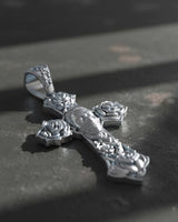 Gothic cross pendant showing intricate skull centerpiece and rose motifs at cross ends in oxidized sterling silver