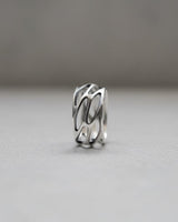 Close-up view of parametric silver ring displaying intricate openwork design and architectural geometric details