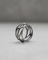 925 sterling silver parametric ring with geometric cutouts displayed on minimalist gray surface showing modern design