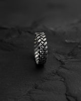 Close-up side view of sterling silver Celtic ring displaying three-dimensional braided knot design and craftsmanship