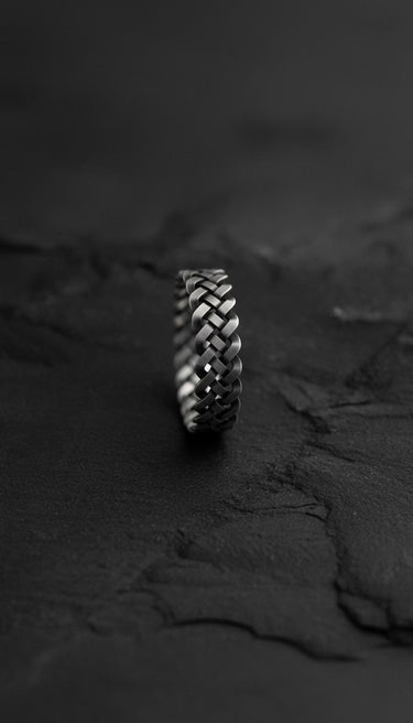 Close-up side view of sterling silver Celtic ring displaying three-dimensional braided knot design and craftsmanship