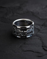 Side angle view of handcrafted dragon ring showing intricate scale details and band cutout design