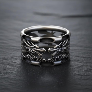 Close-up detail of silver dragon ring displaying carved dragon faces and premium metalwork craftsmanship
