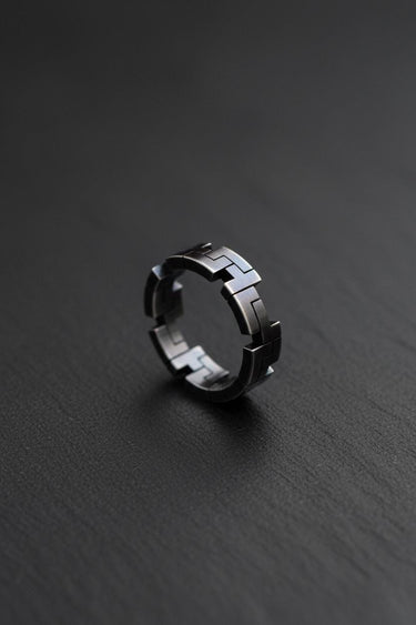 Close-up view of sterling silver geometric ring highlighting precise angular cuts and polished finish details