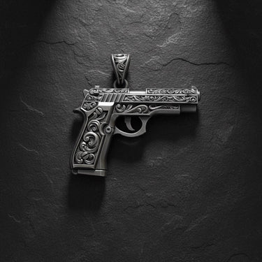 925 sterling silver gun pendant with ornate baroque engravings displayed on dark textured background