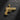 Gold vermeil gun pendant with ornate baroque engravings on the slide and grip, shown on a dark slate background.