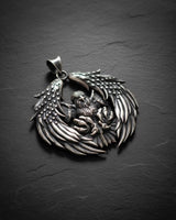 925 sterling silver bald eagle pendant with spread wings and detailed feathers on dark slate background