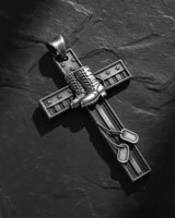Gold vermeil military cross pendant with combat boots and dog tags on dark slate background showing patriotic design