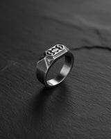 925 sterling silver dwarven ring with geometric patterns displayed on dark slate surface background
