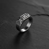 925 sterling silver dwarven ring with geometric patterns displayed on dark slate surface background