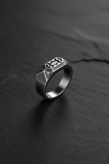 925 sterling silver dwarven ring with geometric patterns displayed on dark slate surface background
