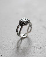 925 sterling silver geometric ring with wireframe diamond design displayed on textured concrete surface