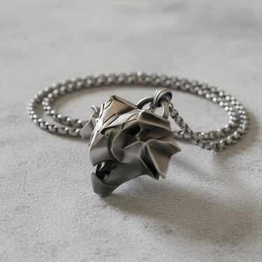 Side angle view of handcrafted griffin medallion showing dimensional depth and oxidized silver finish details