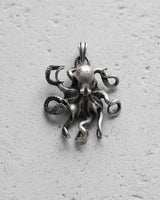 Handcrafted octopus pendant showing realistic head design and curved tentacles in oxidized sterling silver
