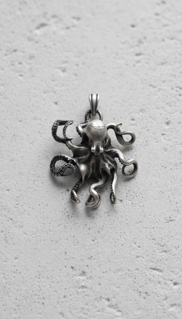 Handcrafted octopus pendant showing realistic head design and curved tentacles in oxidized sterling silver