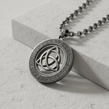 Side angle view of handcrafted triquetra pendant showing oxidized finish and dimensional Celtic symbol detail