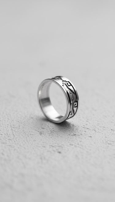 925 sterling silver Aztec ring with Mayan geometric patterns displayed on textured concrete surface showing detail