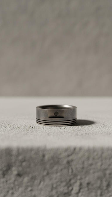 Side view of handcrafted automotive piston ring showing precision engineering details in sterling silver