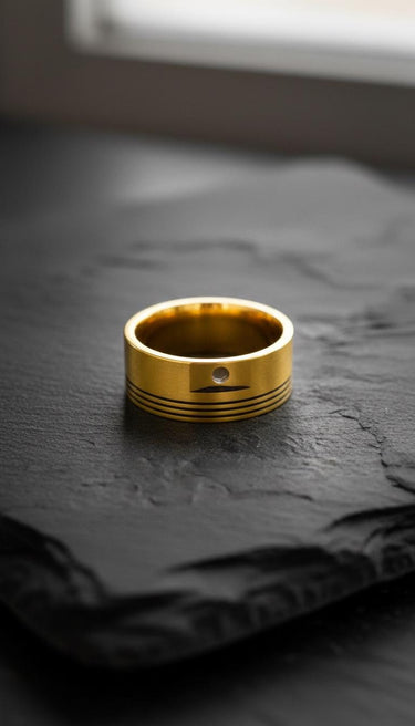 Close-up of golden-toned piston ring displaying industrial design craftsmanship on slate surface