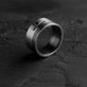 925 sterling silver piston ring with detailed grooves and circular opening on dark textured background