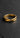 A sterling silver Mobius ring lying flat on a dark slate background, highlighting the elegant infinity curve and form.