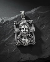 925 sterling silver Jesus cross pendant with rose gold plating and intricate religious design on black slate