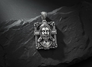 925 sterling silver Jesus cross pendant with rose gold plating and intricate religious design on black slate