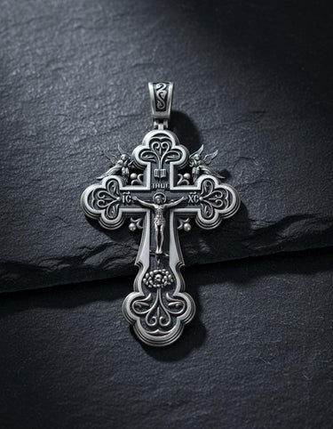 Detailed view of handcrafted Orthodox cross showing intricate metalwork and religious symbols on textured surface