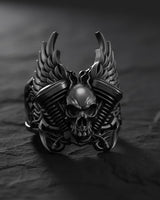 Black oxidized skull engine ring showing gothic biker style with winged skull centerpiece and textured band design