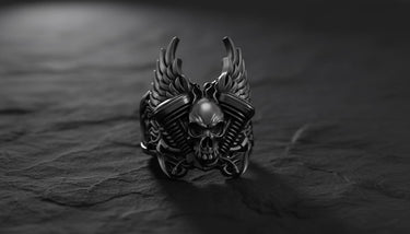 Black oxidized skull engine ring showing gothic biker style with winged skull centerpiece and textured band design