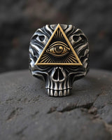 Front view of two-tone skull ring showing detailed metalwork and oxidized silver finish with gold accents