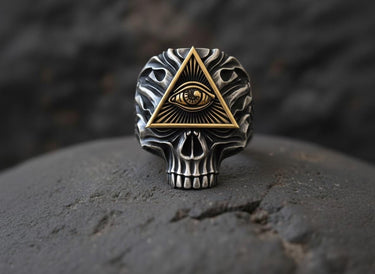 Front view of two-tone skull ring showing detailed metalwork and oxidized silver finish with gold accents