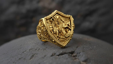 925 sterling silver St George dragon ring with detailed shield design displayed on dark stone surface