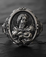 925 sterling silver St Joseph Baby Jesus ring with detailed religious carving and black rhodium finish on wood surface