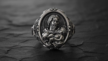 925 sterling silver St Joseph Baby Jesus ring with detailed religious carving and black rhodium finish on wood surface