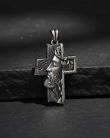 Side angle view of handcrafted Jesus cross pendant showing intricate facial details and oxidized silver finish