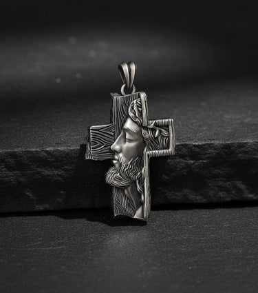 Side angle view of handcrafted Jesus cross pendant showing intricate facial details and oxidized silver finish