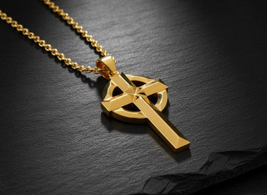 Sterling silver Irish cross necklace with gold finish displayed on chain showing dimensional Celtic knotwork