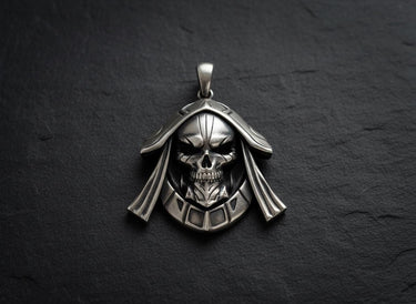 925 sterling silver hooded skull pendant with reaper design displayed on dark slate surface with gold chain
