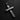 Black and white photo of a rustic silver cross pendant, showing the deep wood grain texture on a dark slate background.