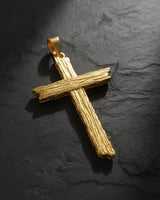 925 sterling silver cross pendant with wood grain texture displayed on dark slate background showing intricate details