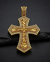 Close-up of diamond-outlined Maltese cross pendant displaying intricate metalwork and romantic engravings
