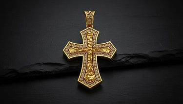 Close-up of diamond-outlined Maltese cross pendant displaying intricate metalwork and romantic engravings