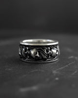 925 sterling silver skull ring with intricate gothic engravings displayed on dark textured background