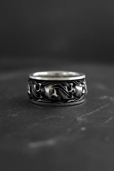 925 sterling silver skull ring with intricate gothic engravings displayed on dark textured background