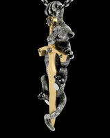 Side angle view of handcrafted panther sword pendant displaying detailed metalwork and pearl claw accents