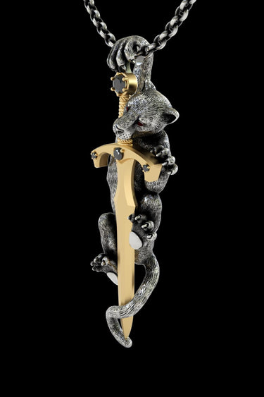 Side angle view of handcrafted panther sword pendant displaying detailed metalwork and pearl claw accents