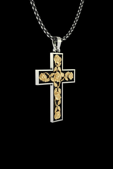 Angled view of the two-tone silver rose cross pendant, highlighting the 3D texture of the gold vermeil roses and vines.