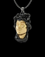 Close-up view of handcrafted Medusa pendant showing intricate serpent hair texture and two-tone finish detail